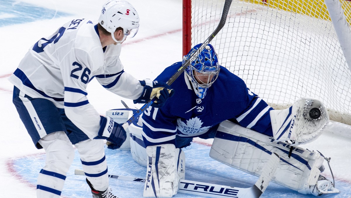 Toronto Maple Leafs goaltender Frederik Andersen (31) makes a save on Jimmy Vesey (26) during the first period Blue versus White scrimmage at NHL hockey training camp in Toronto on Saturday, Jan. 9, 2 ...