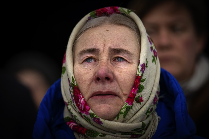 Olha Kosianchuk, 64, weeps during a memorial service marking the one-year anniversary of the start of the war between Russia and Ukraine, in Bucha, Friday, February 24, 2023. Olha's husband was killed during the...