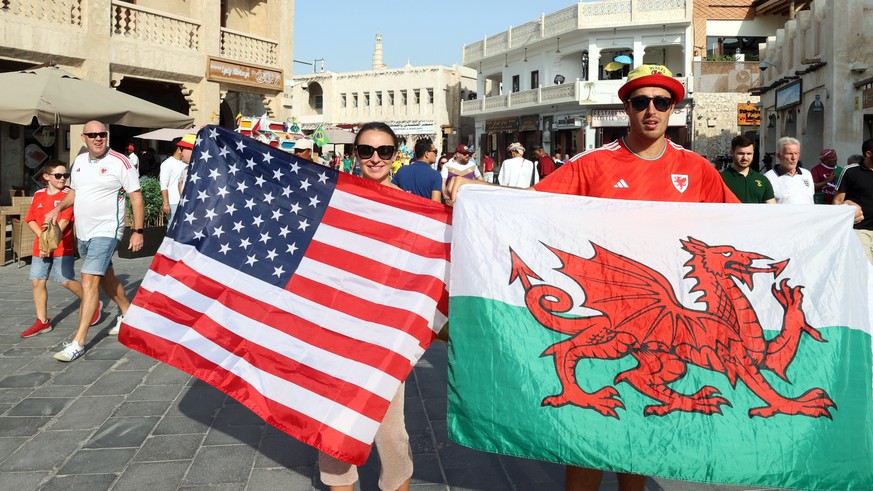 epa10315773 Fans of the US (L) and Wales (R) gather at the traditional market Souq Waqif in Doha, Qatar, 20 November 2022. The USA will face Wales in their FIFA World Cup 2022 group B match on 21 Nove ...