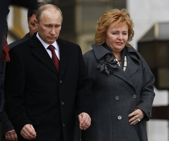 FILE - In this Sunday, March 4, 2012 file photo then Russian Prime Minister and presidential candidate Vladimir Putin and his wife Lyudmila leave a polling station in Moscow, Russia. Russian President ...