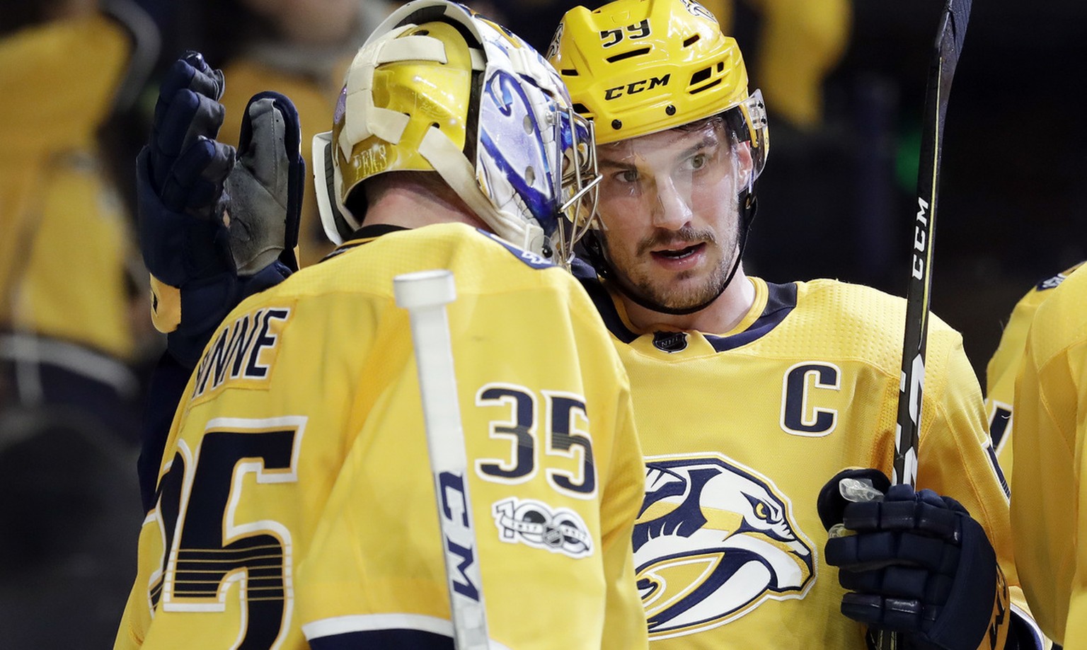 Nashville Predators defenseman Roman Josi (59), of Switzerland, celebrates with goalie Pekka Rinne (35), of Finland, after the Predators beat the Chicago Blackhawks 3-2 in an NHL hockey game Tuesday,  ...