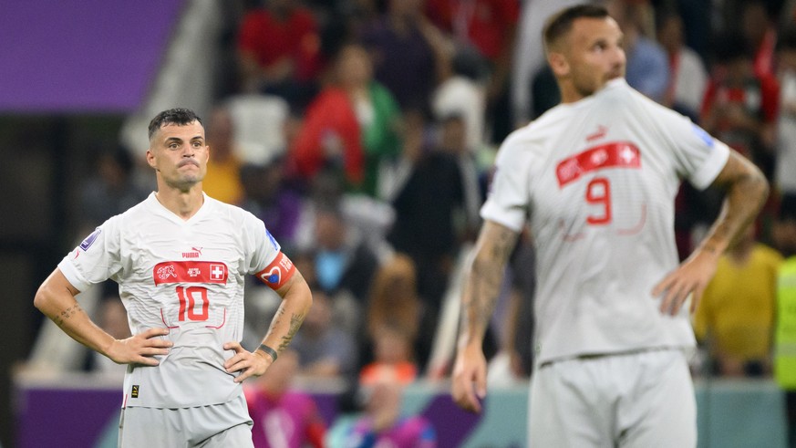 Switzerland's midfielder Granit Xhaka and Switzerland's forward Haris Seferovic, right, react after the Portugal's fifth goal during the FIFA World Cup Qatar 2022 round of 16 soccer match between Port ...