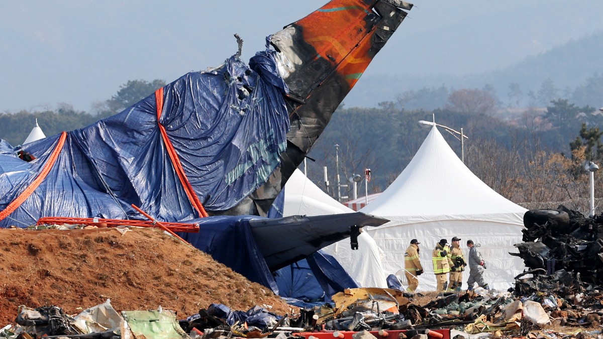 epa11819498 Firefighters inspect the site of a Jeju Air plane accident at Muan International Airport in Muan County, South Korea, 12 January 2025, following its crash on 29 December 2024. EPA/YONHAP S ...