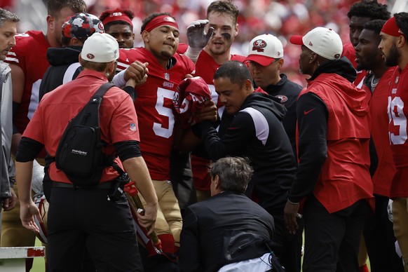 San Francisco 49ers quarterback Trey Lance (5) is helped onto a cart during the first half of an NFL football game against the Seattle Seahawks in Santa Clara, Calif., Sunday, Sept. 18, 2022. (AP Phot ...