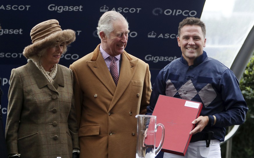 Britain&#039;s Prince Charles and the Duchess of Cornwall pose for the media with former England soccer player Michael Owen who rode Calder Prince in the Prince&#039;s Countryside Fund race at Ascot R ...
