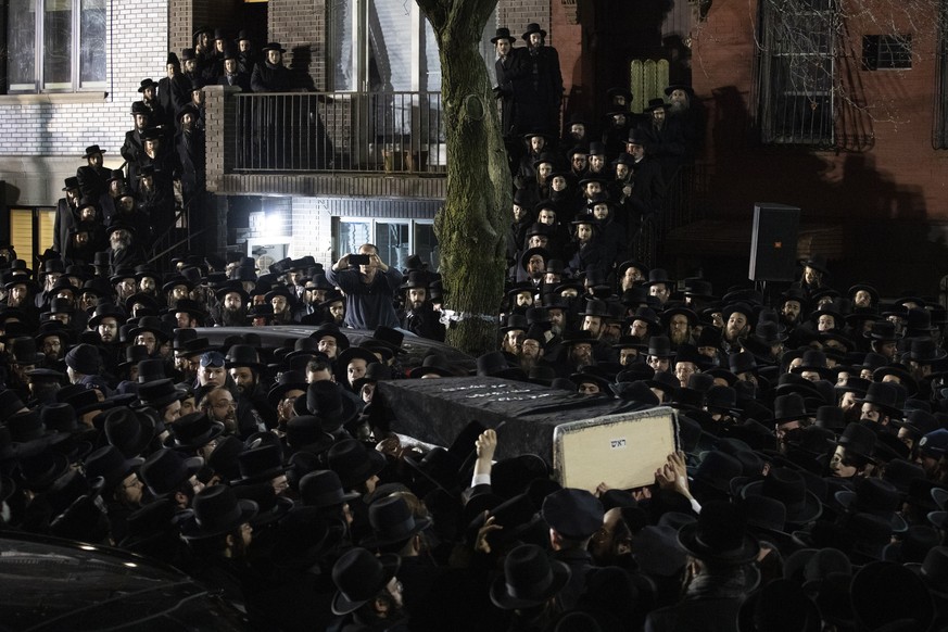 Orthodox Jewish men carry Moshe Deutsch&#039;s casket outside a Brooklyn synagogue following his funeral, Wednesday, Dec. 11, 2019 in New York. Deutsch was killed Tuesday in a shooting inside a Jersey ...