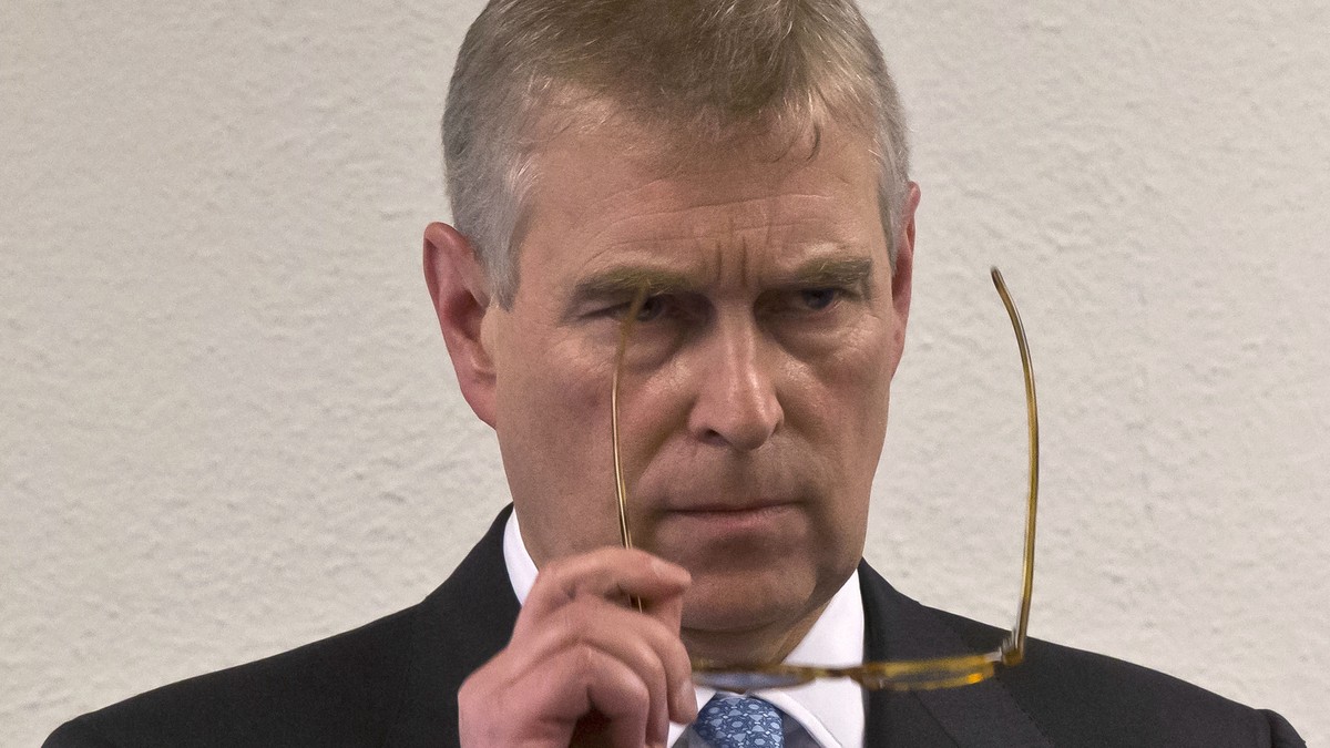 FILE - In this file photo dated Thursday, Jan. 22, 2015, Britain's Prince Andrew, puts on his glasses prior to his speech to business leaders during a reception at the sideline of the World Econo ...