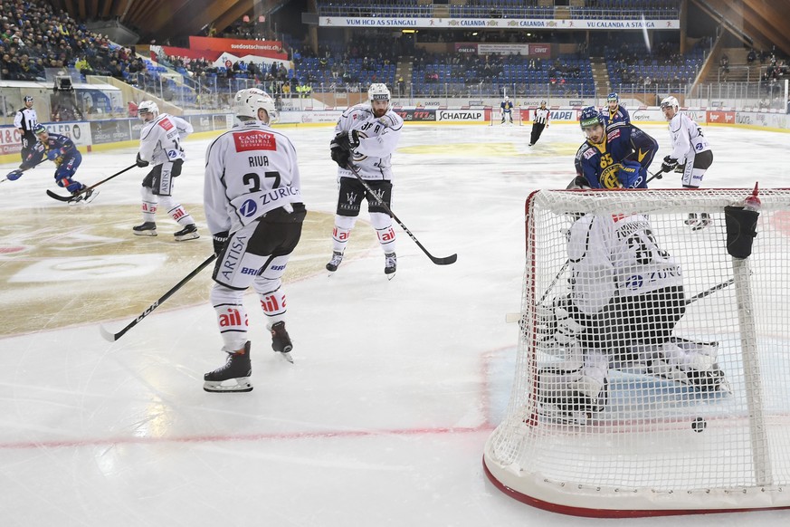 Davos&#039; Otso Rantakari, links, erzielt das 2-2 gegen Luganos Torhueter Sandro Zurkirchen, beim Eishockey-Qualifikationsspiel der National League A zwischen dem HC Davos und dem HC Lugano, am Diens ...