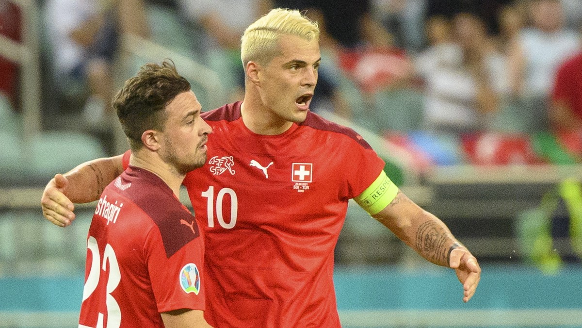 epa09288931 Switzerland's midfielder Xherdan Shaqiri (L) celebrates the second goal with Switzerland's midfielder Granit Xhaka during the UEFA EURO 2020 group A preliminary round soccer matc ...