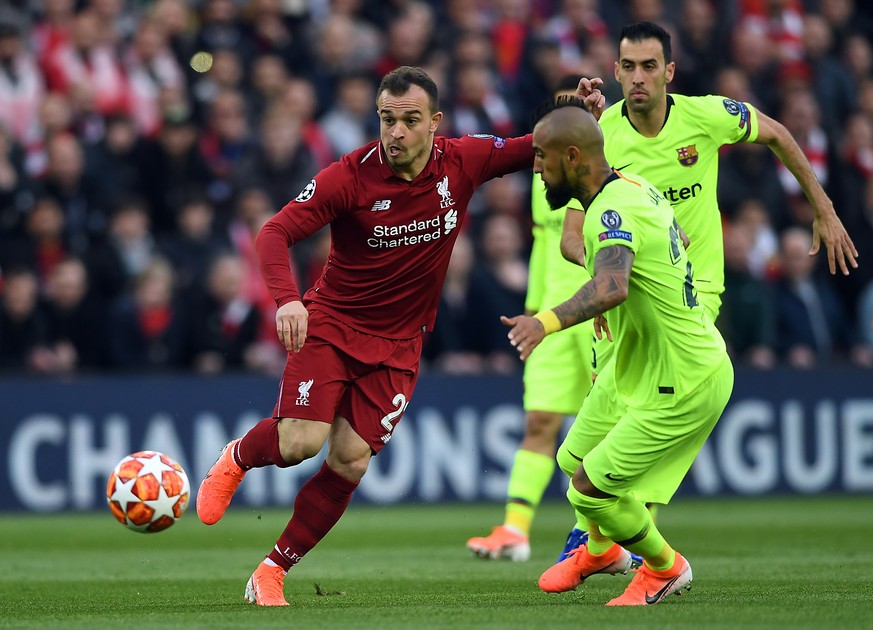 epa07554429 Xherdan Shaqiri (L) of Liverpool and Arturo Vidal of Barcelona (R) in action during the UEFA Champions League semi final 2nd leg match between Liverpool FC and FC Barcelona at Anfield, Liv ...