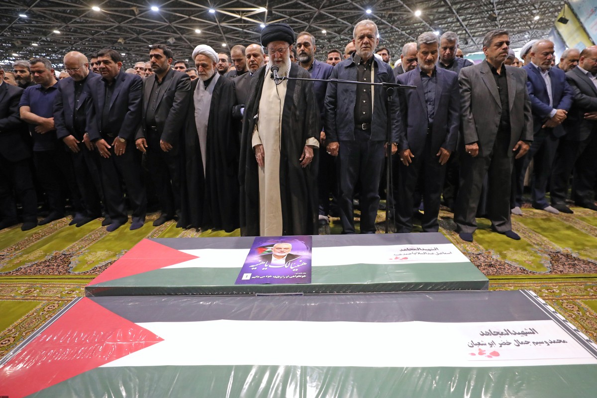 epa11515324 A handout photo made available by the Iranian Supreme Leader's Office shows Supreme Leader Ayatollah Ali Khamenei (front) leading a prayer before the coffins of late Hamas leader Isma ...