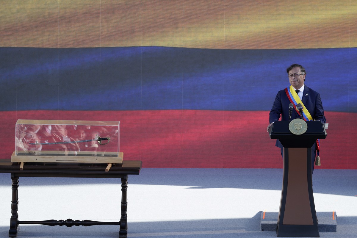 epa10110791 Colombian President Gustavo Petro, with Bolivar's sword next to him, delivers his investiture speech in the Plaza Bolivar in Bogota, Colombia, 07 August 2022. Thousands of people gath ...