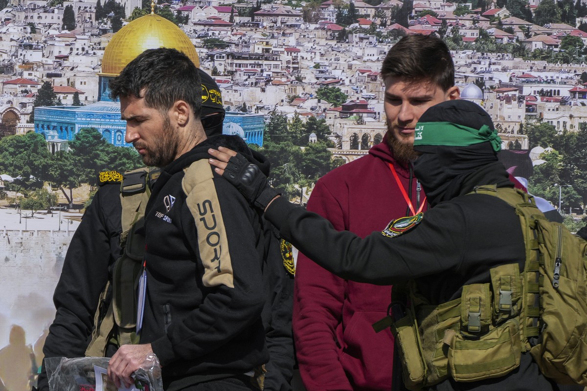 Israeli-American hostage Sagui Dekel Chen, 36, left, and Israeli-Russian Alexander Troufanov, 29, are escorted by Hamas and Islamic Jihad fighters before being handed over to the Red Cross in Khan You ...