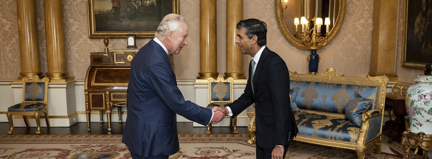 King Charles III welcomes Rishi Sunak during an audience at Buckingham Palace, London, where he invited the newly elected leader of the Conservative Party to become Prime Minister and form a new gover ...