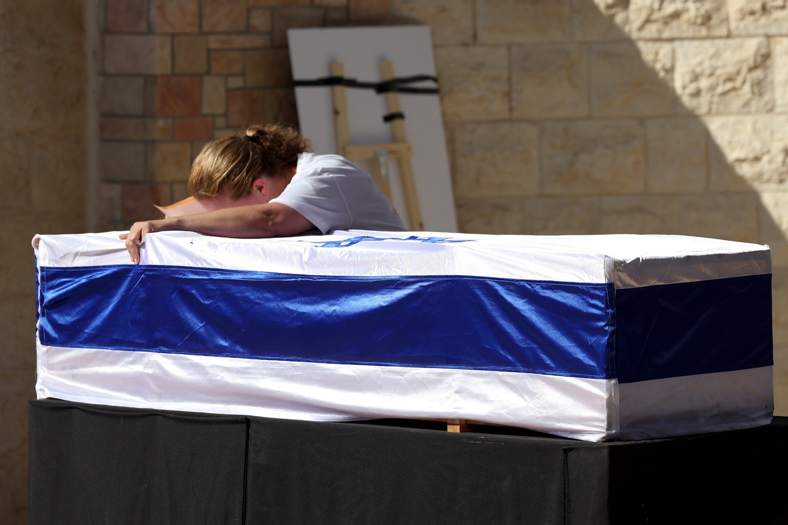 epa10980407 Adi Marciano mourns on the coffin of her daughter, Israeli soldier Noa Marciano, during her funeral in Modiin, Israel, 17 November 2023. Noa Marciano&#039;s body was found and extracted on ...