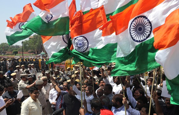 epa10561195 MPs from Indian opposition parties led by the Indian National Congress Party (INC) hold the Indian national flag as they take part in a protest march to demand a common parliament...
