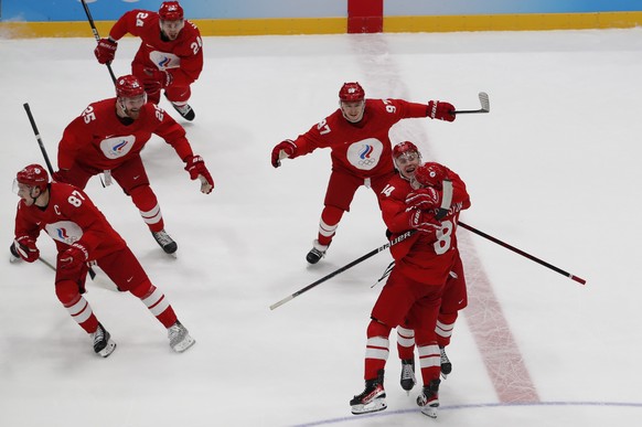 epa09769721 Arseni Gritsyuk (R) of Russia celebrates with teammates after winning the Men&#039;s Ice Hockey semi final match between Sweden and Russian Olympic Comittee at the Beijing 2022 Olympic Gam ...