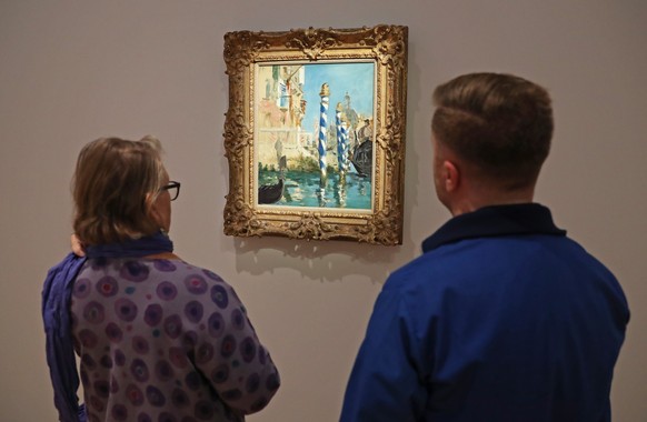 epa10277353 People view &#039;Le Grand Canal a Venise&#039; by French painter Edouard Manet, estimated at 45 to 65 million USD, during a preview of the sale &#039;Visionary: The Collection of Paul G.  ...