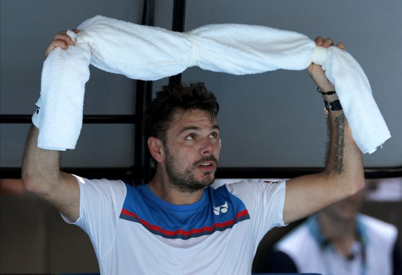 Switzerland&#039;s Stan Wawrinka places an ice towel around his neck during his first round match against Damir Dzumhur of Bosnia and Herzegovina at the Australian Open tennis championship in Melbourn ...