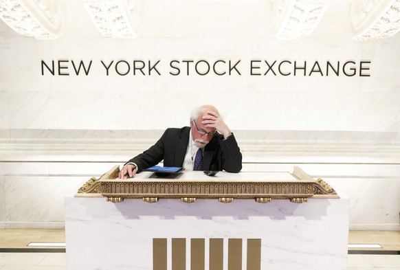 epa08297982 Trader Peter Tuchman works at a podium normally reserved for guests at the opening bell at the New York Stock Exchange in New York, New York, USA, 16 March 2020. Stocks opened sharply lowe ...