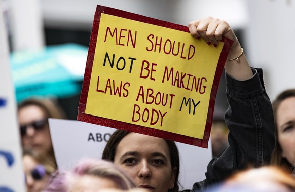 epa07590165 A woman holds a poster reading &#039;Men Should Not Be Making Laws About My Body&#039; as pro-abortion protesters demonstrate at the West Hollywood City Hall in Hollywood, California, USA, ...