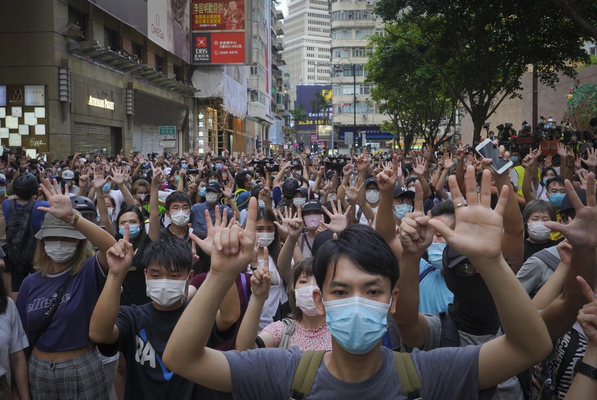FILE - In this Wednesday, July. 1, 2020 file photo, protesters against the new national security law gesture with five fingers, signifying the "Five demands - not one less" on the anniversar ...