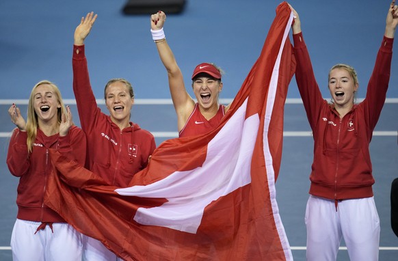 Switzerland's players Jil Teichmann, Viktorija Golubic, Belinda Bencic and Simona Waltert, from left, celebrates after defeating Australia to win the Billie Jean King Cup tennis finals, at the Em ...