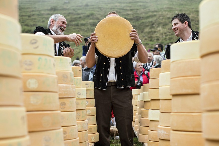 epa04936862 epa04936860 Dairy farmers attend traditional Chaesteilet (lit.: sharing the cheese) in Justistal, Switzerland, 18 September 2015. The local farmers whose cows have spend the summer on the  ...