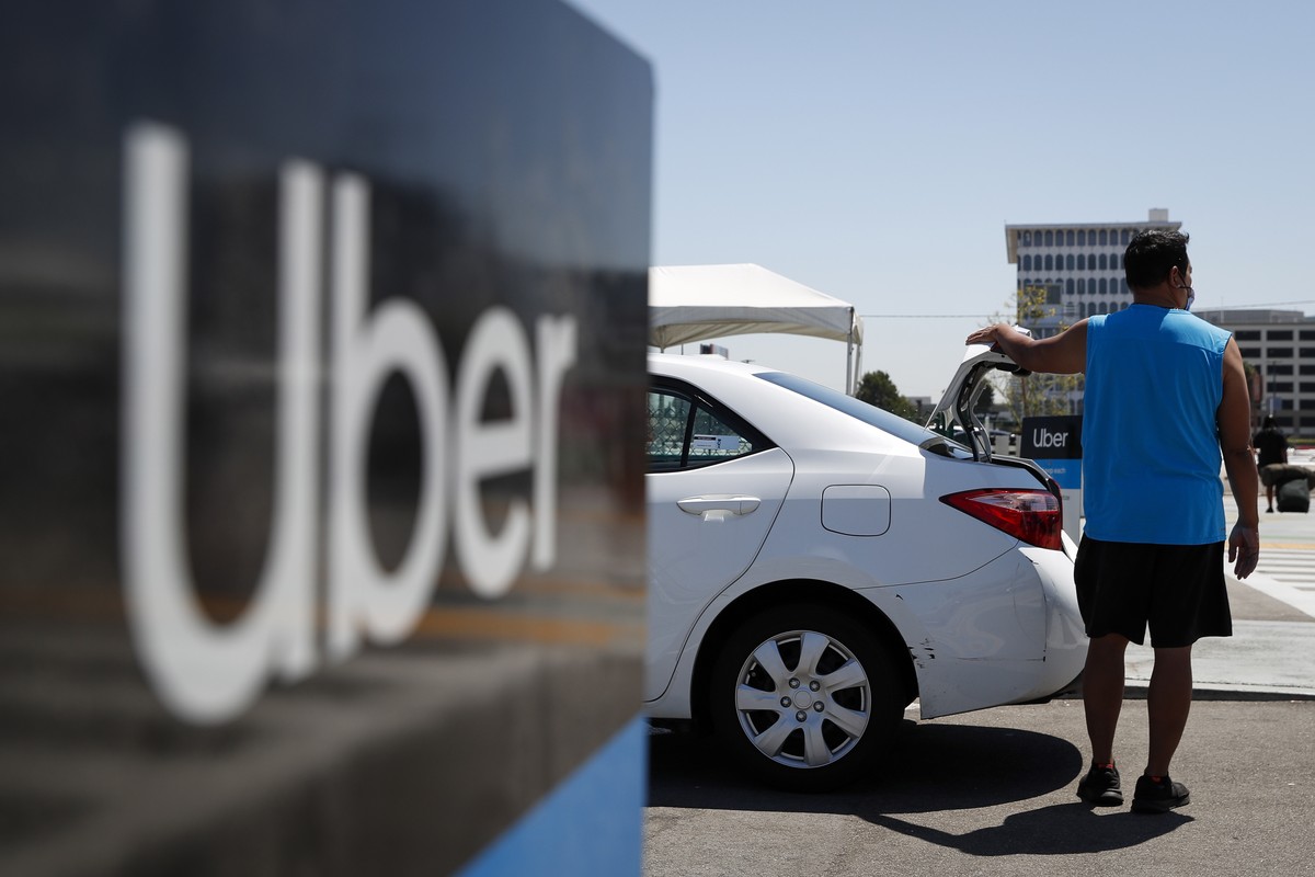 epa09395793 An Uber driver waits for passengers at the Los Angeles International Airport's LAX-it pick up terminal in Los Angeles, California, USA, 04 August 2021. The LAX-it pick up terminal was ...