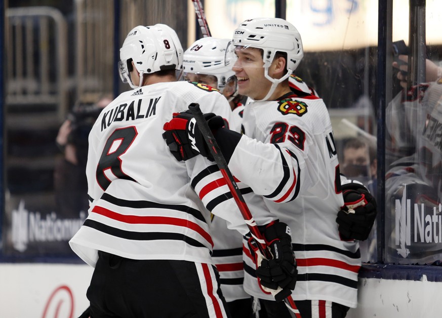 Chicago Blackhawks forward Philipp Kurashev, right, celebrates his goal against the Columbus Blue Jackets with teammate forward Dominik Kubalik, left, and forward Patrick Kane during the third period  ...