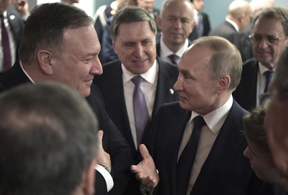 epa08141943 US Secretary of State Mike Pompeo (L) speaks with Russian President Vladimir Putin (2nd-R) during the International Libya Conference in Berlin, Germany, 19 January 2020. By means of the &# ...