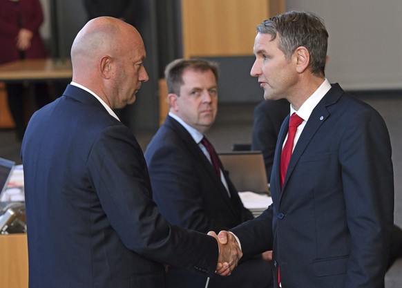 AfD parliamentary party leader Bjoern Hoecke, right, shakes hands with Thomas Kemmerich of the Free Democrats, in Erfurt, Germany, Wednesday, Feb. 5, 2020. Kemmerich, a pro-business politician, has be ...