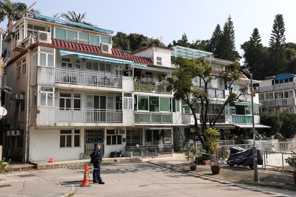 epa10491700 Police stand guard outside a village house where the remains of Hong Kong model Abby Choi Tin-fung were found, in Lung Mei Tsuen, Tai Po, Hong Kong China, 26 February 2023. Police arrested ...