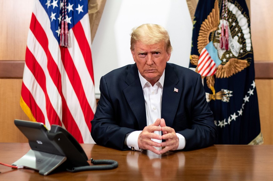 epa08721426 A handout photo released by the White House shows US President Donald J. Trump during a phone call with US Vice President Mike Pence, Secretary of State Mike Pompeo, and Chairman of the Jo ...