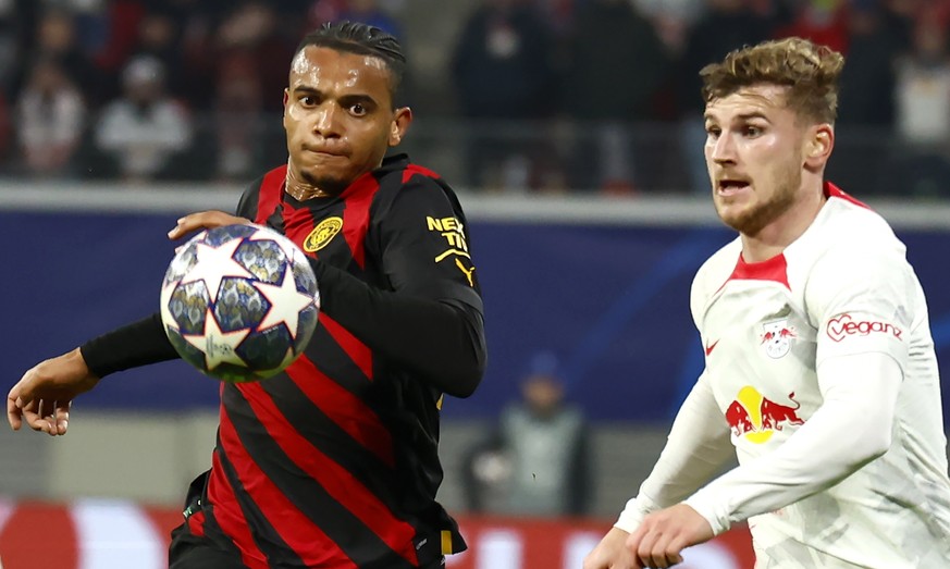 epa10484402 Timo Werner (R) of Leipzig in action against Manuel Akanji of Manchester City during the UEFA Champions League, Round of 16, 1st leg between RB Leipzig and Manchester City in Leipzig, Germ ...