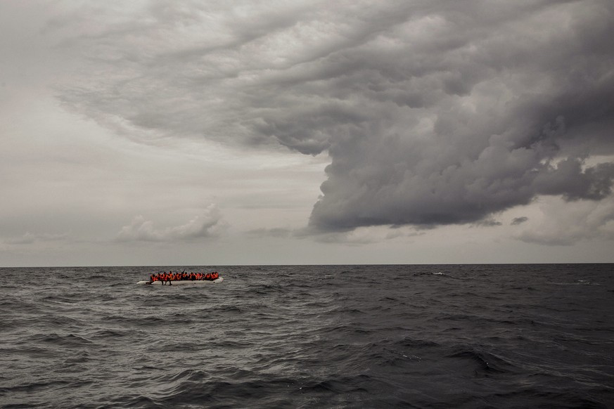 In this photo taken on Sunday Feb. 18, 2018 photo, refugees and migrants wait to be rescued by aid workers of the Spanish NGO Proactiva Open Arms, after leaving Libya trying to reach European soil abo ...