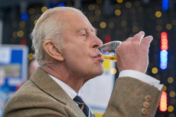 Britain's King Charles III tastes a dram of 25-year-old Glen Scotia Single Malt whisky during a reception at Campbeltown Town Hall, to join a community reception before meeting members of the pub ...