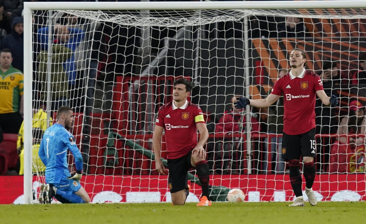Manchester, England, 13th April 2023. Harry Maguire of Manchester United, ManU dejected after Sevillas second goal cannoned off his head wrong footing David De Gea of Manchester United during the UEFA ...