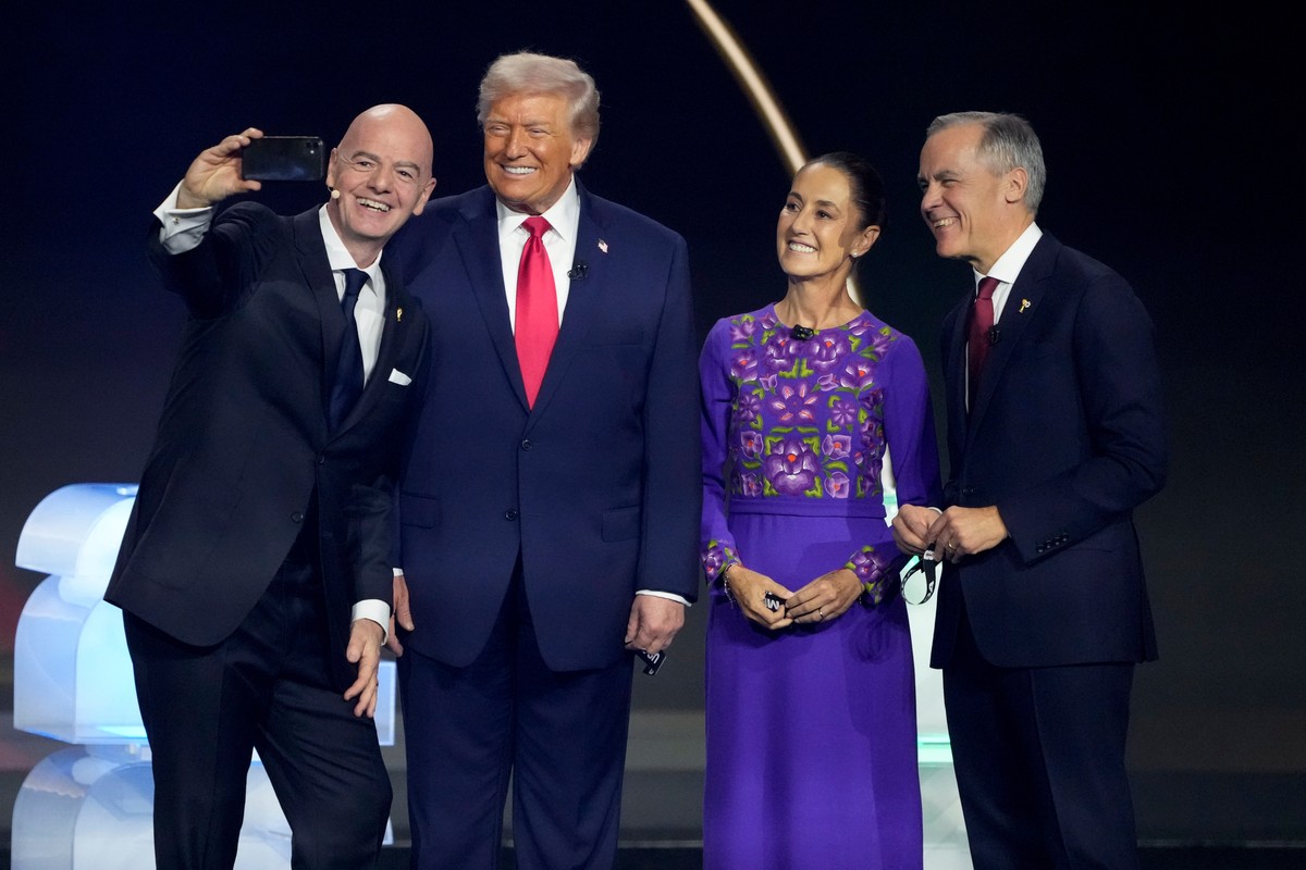From left; FIFA President Gianni Infantino takes a selfie with President Donald Trump, Mexican President Claudia Sheinbaum, and Canadian Prime Minister Mark Carney during the draw for the 2026 soccer  ...