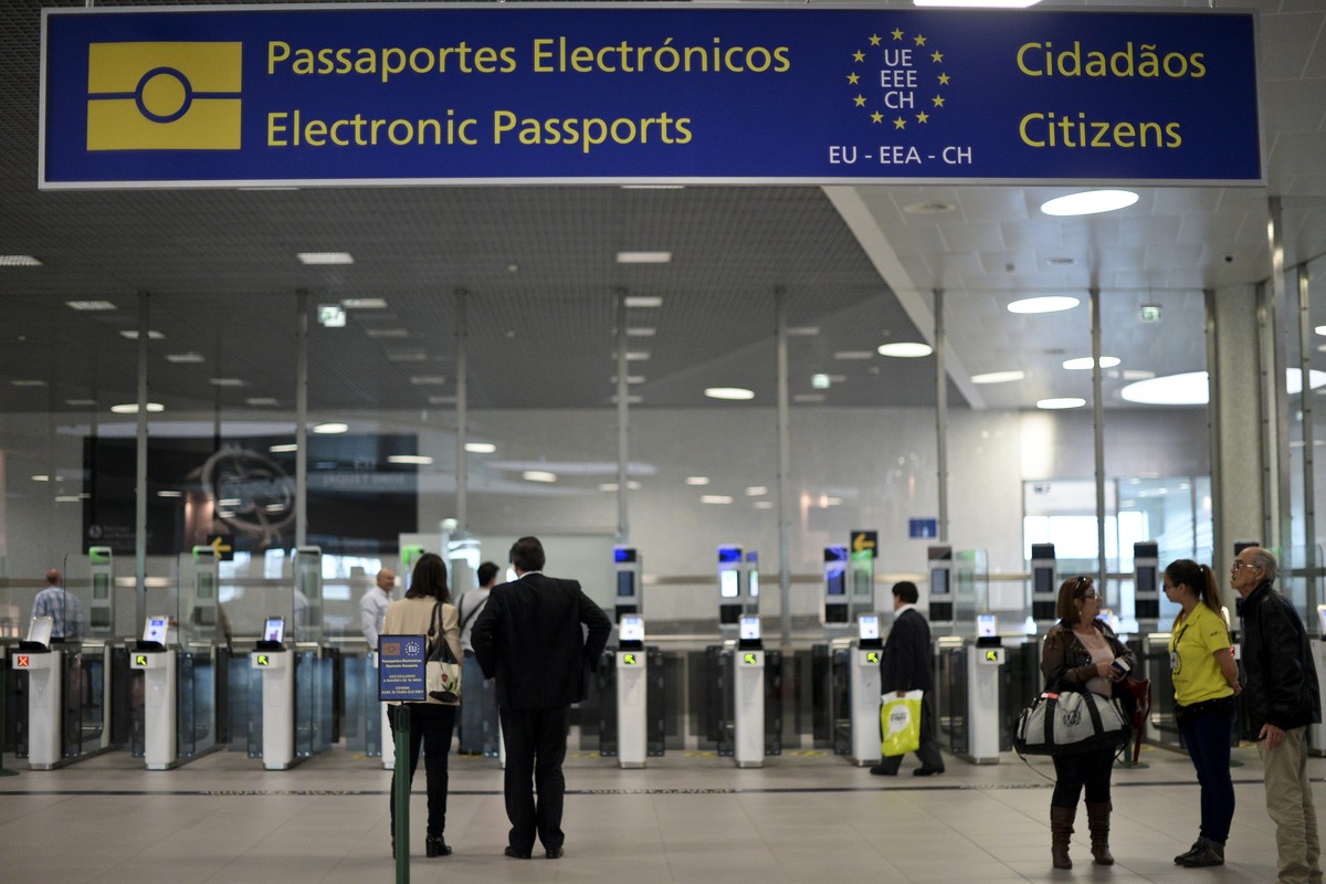 Des voyageurs utilisant les bornes d'enregistrement automatique "eGate" pour le contrôle des frontières à l'aéroport de Lisbonne