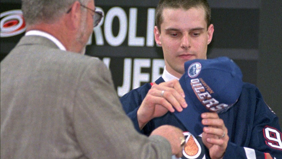 First round pick Switzerland's Michel Riesen looks at the team cap after being selected by Edmonton in the NHL draft in Pittsburgh Pa. Saturday June 21, 1997. (AP Photo/Gene J. Puskar)