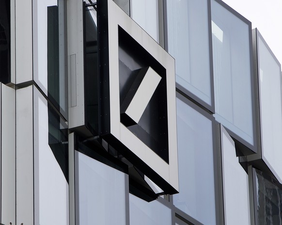FILE - In this April 9, 2018 file photo, the Deutsche Bank bank logo is seen on the bank&#039;s building, in Frankfurt, Germany. Deutsche Bank saw its net profit increase 6%, to 329 million euros ($38 ...