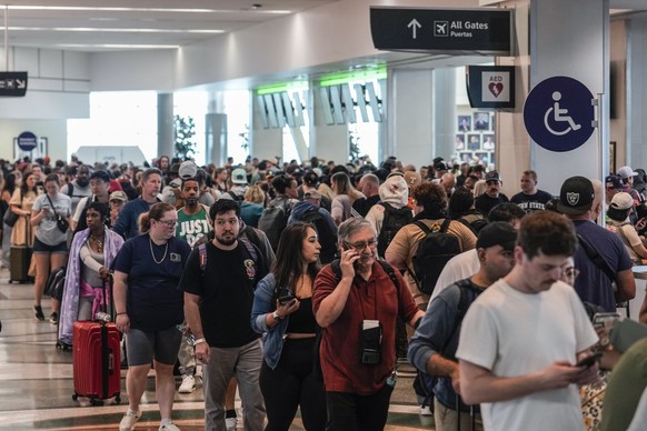 HOUSTON, TEXAS - MARCH 8: Airline passengers wait in long lines to get through the TSA security screening at William P. Hobby Airport in Houston, Sunday, March 8, 2026. The line stretched from the sec ...