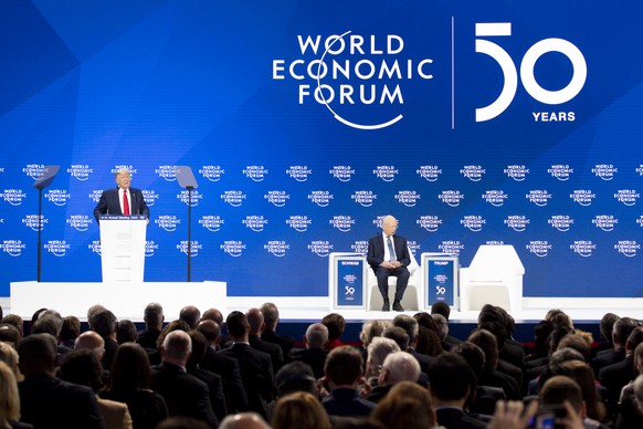 US President Donald Trump, left, addresses next to German Klaus Schwab, right, Founder and Executive Chairman of the World Economic Forum, WEF, during a plenary session during to the 50th annual meeting of the World Economic Forum, WEF, in Davos, Switzerland, Tuesday, January 21, 2020. The meeting brings together entrepreneurs, scientists, corporate and political leaders in Davos from January 21 to 24. (KEYSTONE/Gian Ehrenzeller)