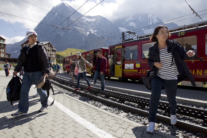 ARCHIVBILD ZUR JAHRESBILANZ 2017 DER JUNGFRAUBAHN -- Touristen steigen aus einem Zug der Jungfraubahn unterhalb des Eigers am Freitag, 26. August 2011, auf der kleinen Scheidegg. (KEYSTONE/Peter Klaun ...