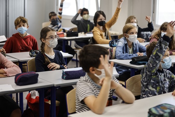 FILE - In this Sept. 2, 2021, file photo, children sit in a classroom at school in Strasbourg, eastern France. Children across Europe are going back to school, with hopes of a return to normality afte ...