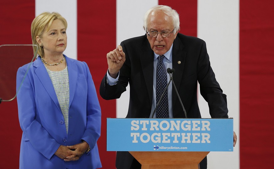 epa05421988 Democratic Presidential candidate Hillary Clinton (L) with former Democratic Presidential candidate Bernie Sanders as they appear together at an event at Portsmouth High School in Portsmou ...