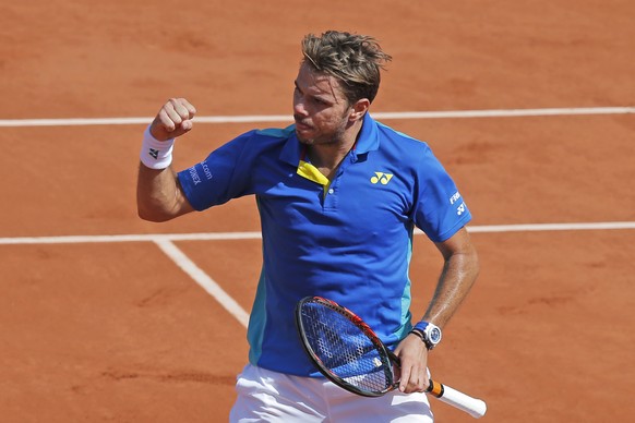 Switzerland&#039;s Stan Wawrinka clenches his fist after scoring a point against France&#039;s Gael Monfils during their fourth round match of the French Open tennis tournament at the Roland Garros st ...