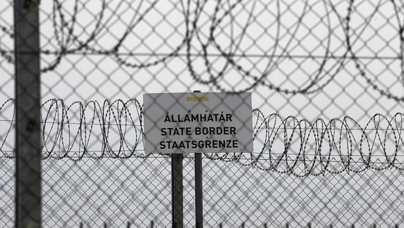 FILE - In this file photo dated Monday, April 8, 2019, a sign reading: &quot;State Border&quot; is attached to a fence at Hungary's border with Serbia near the village Asotthalom, Hungary. The Europea ...
