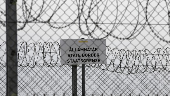 FILE - In this file photo dated Monday, April 8, 2019, a sign reading: &quot;State Border&quot; is attached to a fence at Hungary&#039;s border with Serbia near the village Asotthalom, Hungary. The Eu ...